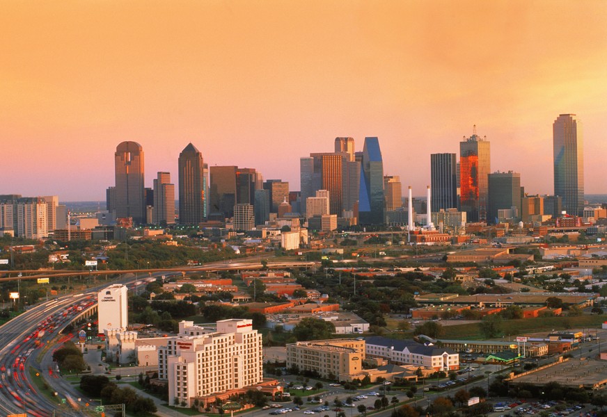 Highway traffic passing around Dallas skyline at dusk (Newscom TagID: scphotos111175) [Photo via Newscom]